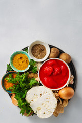 Ingredients cooking curry cauliflower concrete background top view