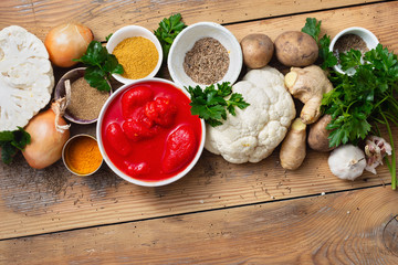 Curry cauliflower raw ingredients cooking wooden background top view
