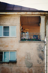 Fragment of an old building with a beautiful balcony. Retro style.