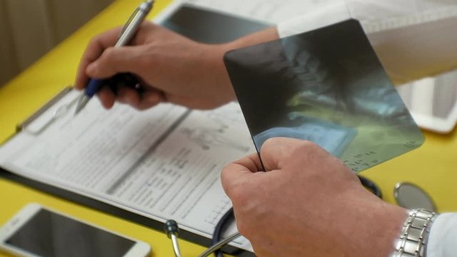 Healthcare and medical concept. X-ray image on the screen of a digital tablet. Medical table side view.