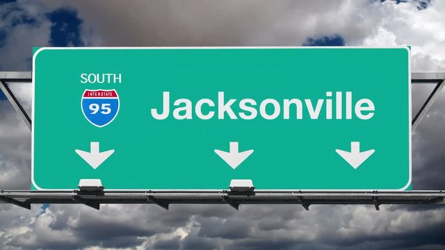 Jacksonville Florida interstate route 95 overhead freeway directional arrow sign with time lapse clouds.