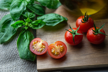 Sliced cherry tomatoes on wooden tray