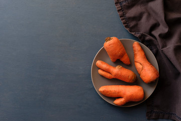 Carrots with double shapes on dark background