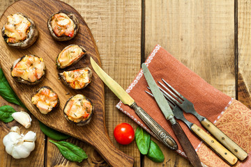 Baked champignons on a kitchen board.
