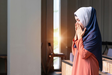 Muslim woman praying in public, concept religion of Islam