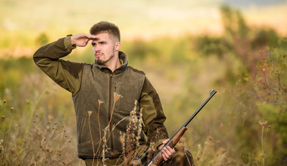 Hunting and trapping seasons. Man brutal unshaved gamekeeper nature background. Hunting permit. Bearded serious hunter spend leisure hunting. Hunter hold rifle. Hunting is brutal masculine hobby