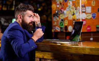 Surfing internet. Man bearded businessman sit pub with laptop and cup of coffee. Manager work online while enjoy coffee. Online job. Hipster freelancer work online blog notebook. Freelance benefit