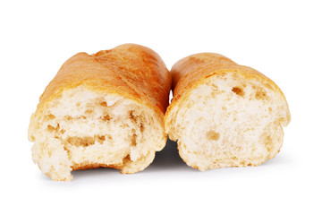 Baguette bread is broken in half on a white background