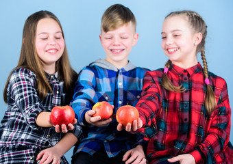 Fototapeta na wymiar Promoting healthy nutrition. Group teenagers cheerful kids hold apples. Boy and girls friends eat apple. Teens with healthy snack. Healthy dieting and vitamin nutrition. Eat fruit and be healthy