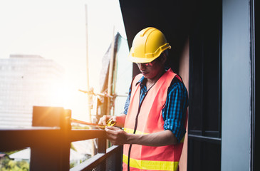 construction worker use measuring tape of balcony