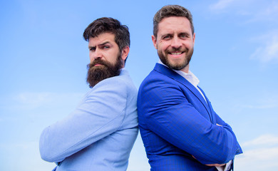 Perfect in every detail. Business men stand blue sky background. Well groomed appearance improves...