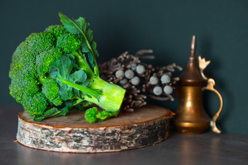 Fresh bright green broccoli on a wooden stand surrounded by beautiful scenery.