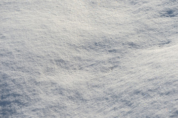 White snow texture on a sunny day. Winter background