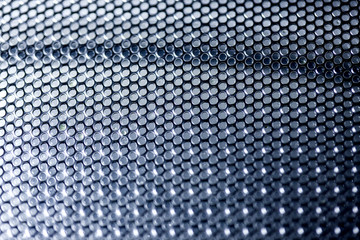 metallic mesh on a blue background. Whole background.