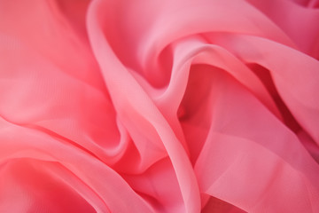 Pink georgette fabrics. The purple texture of the pleated fabric..