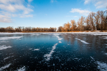 frozen lake with clear ice and bits of snow