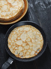 Traditional pancakes on a dark wooden background