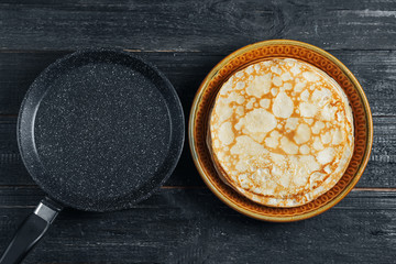 Traditional pancakes on a dark wooden background