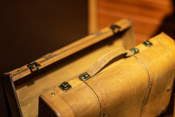 Yellow wooden suitcase for travel closeup, nostalgic luggage, vintage background