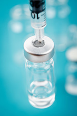 Vaccine vial dose with needle syringe.