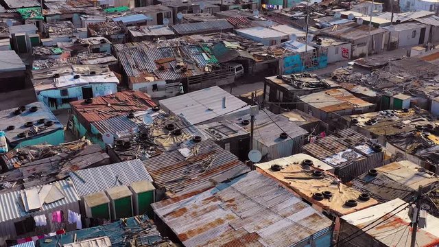 Aerial over ramshackle tin roofs of Gugulethu, one of the poverty stricken slums, ghetto, or townships of South Africa.