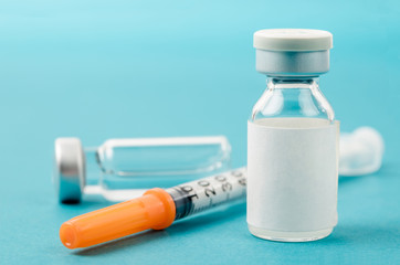 Vaccine vial dose with needle syringe.