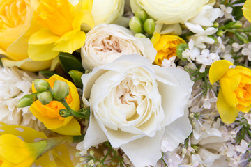 Floral, flowers background. White roses and yellow narcissus macro, close-up in beautiful spring bouquet