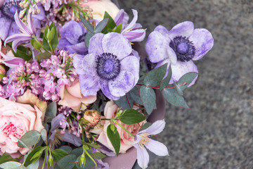 Floral, flowers background. Beautiful violet bouquet by florist with different flowers and roses close-up, macro