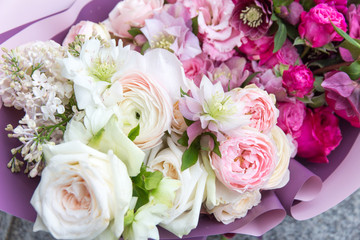 Beautiful elegant wedding bouquet, flowers arrangement by florist with white and pink roses and lilac close up . Floral background