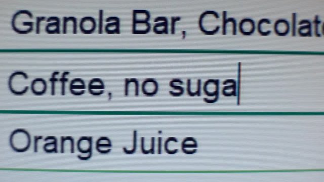 Person entering data with daily food and drinks into table with calories, diet