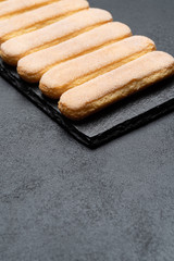 Italian Savoiardi ladyfingers Biscuits on concrete backgound