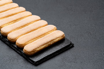 Italian Savoiardi ladyfingers Biscuits on concrete backgound