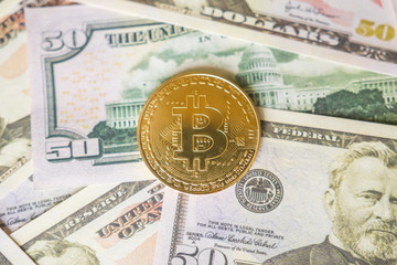 Bitcoin cryptocurrency on us dollars close up. Business concept of crypto currency.
