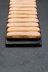 Italian Savoiardi ladyfingers Biscuits on concrete backgound
