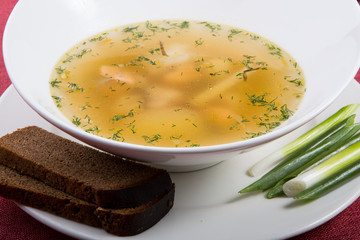 Yellow chicken soup served with leek