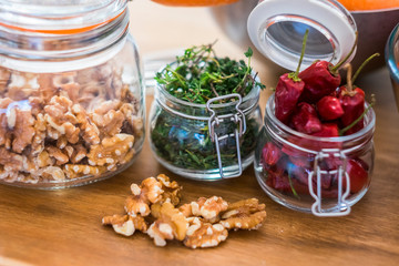Close up of fresh healthy food ingredients like nuts and chiully pepper - piece of tqable in the kitchen - restaurant and fresh fruits and vegatables