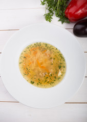 Yellow chicken soup served with leek