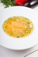 Yellow chicken soup served with leek