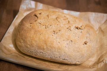 Homemade bread of wheat flour on the wood board