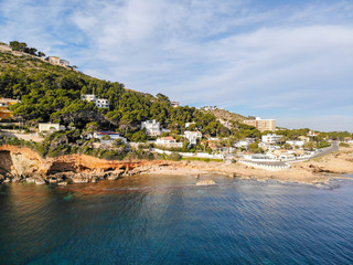 Aerial view of Las Rotas rocky beach in Denia, Spain at sunset