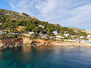 Aerial view of Las Rotas rocky beach in Denia, Spain at sunset