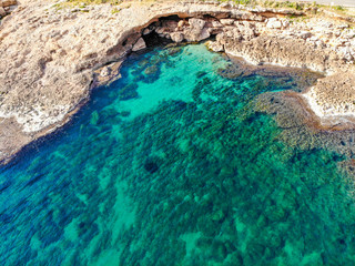 Aerial view of Las Rotas rocky beach in Denia, Spain at sunset