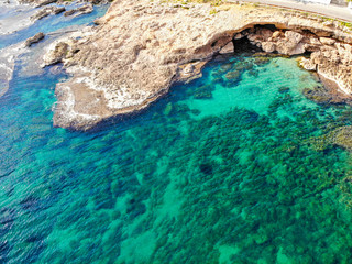 Fototapeta premium Aerial view of Las Rotas rocky beach in Denia, Spain at sunset