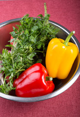 Bell pepper with parsley in a metal bowl in kitchen