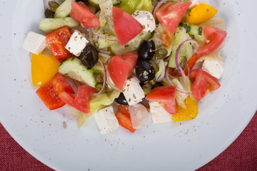 Mixed fresh greek salad on a plate