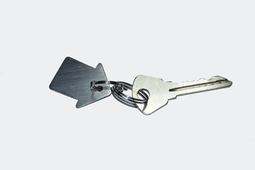 Key with homemade keychain in the shape of a house isolated on white background
