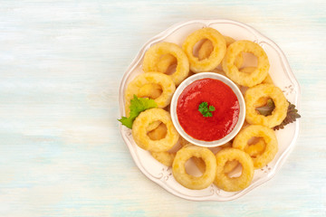 Squid rings, shot from the top with a tomato dip and a place for text