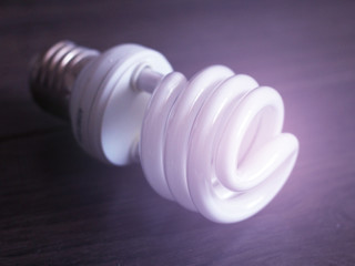 Light bulb on wooden background