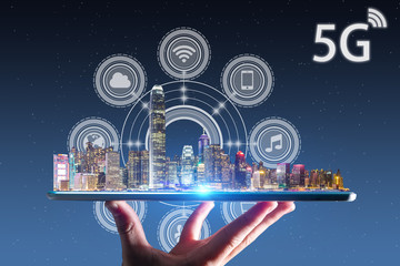 Waiter hand holding an empty digital tablet with smart city and 5G network wireless systems and internet of things
