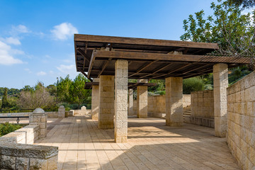 Stone, a large arbor in the background of mountains on a sunny, summer day